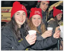  ?? ALISON JENKINS/JOURNAL PIONEER ?? Megan Rodger, left, and Dakota MacWilliam­s serve up hot chocolate to the crowd at the Lights for Life Wednesday.