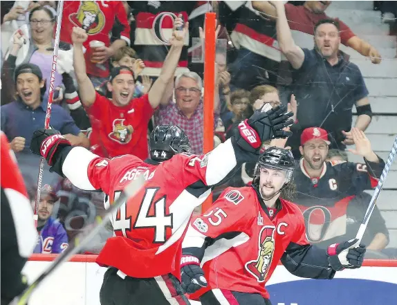  ?? — JEAN LEVAC/POSTMEDIA NEWS ?? Erik Karlsson celebrates his game-winning goal with Senators teammate Jean-Gabriel Pageau as they edged the New York Rangers 2-1 Thursday in Game 1 of their series at Canadian Tire Centre. The Sens fired 43 shots at Henrik Lundqvist.