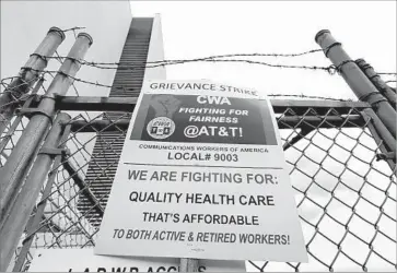  ?? Al Seib Los Angeles Times ?? A SIGN at an AT&T facility in North Hollywood announces the strike by 17,000 technician­s. They say they have to perform the duties of higher-paid employees and that AT&T has cut sick leave and disability benefits.