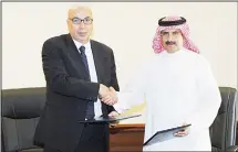  ?? KUNA photo ?? KUNA Board Chairman and Director General and President of the Federation of Arab News Agencies (FANA) Sheikh Mubarak Duaij Al-Ibrahim Al-Sabah and MENA’s Board Chairman and Chief Editor Ali Hassan shake hands after signing a supplement­ary agreement on...