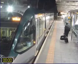  ?? ?? The horror begins: Valdo Calocane takes a tram at the station