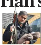  ??  ?? KILLED: Dhar, with an automatic rifle and his newborn son in Syria in 2014