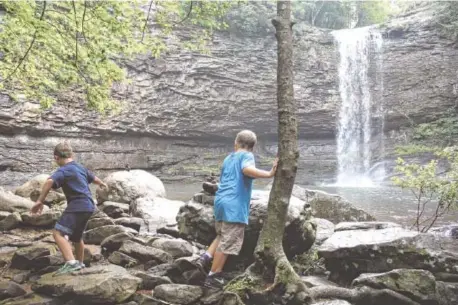  ?? STAFF FILE PHOTO ?? Twins Joshua, right, and Jacob Schenk explore the shore area by one of Cloudland Canyon’s waterfalls while taking a break from hiking.