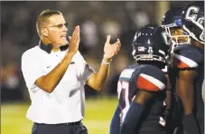  ?? Stephen Dunn / Associated Press ?? UConn coach Randy Edsall encourages his team during a timeout in an Aug. 30 game against UCF.