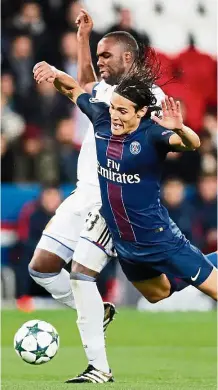  ?? — EPA ?? Outta my way: Paris St Germain’s Edinson Cavani is bundled out by Basel’s Eder Balanta during the Champions League Group A match at Parc des Princes on Wednesday.