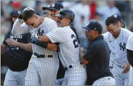  ?? NOAH K. MURRAY – THE ASSOCIATED PRESS ?? The Yankees’ Aaron Judge, left, celebrates with Matt Carpenter and his teammates after hitting a game-ending three-run homer in the 10th inning to beat the Astros on Sunday.