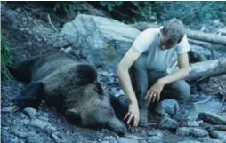  ?? BERT GILDART ?? Ranger Leonard Landa with the body of the bear that killed Michele Koons in 1967.