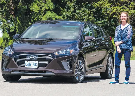  ?? PHOTOS: GAVIN YOUNG ?? Gillian Macartney with the 2017 Hyundai Ioniq she test drove. “The car was bigger than I thought it would be,” Macartney says.