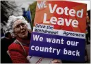  ?? DAN KITWOOD / ?? A woman supporting the ‘Leave’ campaign holds a sign outside the House of Commons on Tuesday in London.