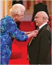  ??  ?? Proud: reg receiving his Mbe from the Queen