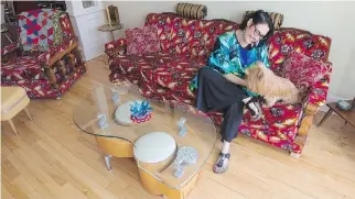  ?? PHOTOS: PHIL CARPENTER/MONTREAL GAZETTE ?? Stephanie Carrière plays with her dog Bamboo in the retro-furnished home she shares with her husband, profession­al jeweller Jean-Luc Bensadoun,