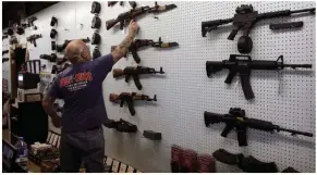  ?? Photograph: AP ?? A selection of guns on sale at a store in Colorado Springs
