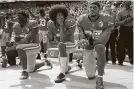  ?? Tribune News Service file photo ?? Colin Kaepernick, center, began kneeling in 2016 during the national anthem to protest police brutality.