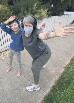  ??  ?? BUST A MOVE: Horsham’s Amy Anselmi and son Asher dance in their street to help beat the stress of another statewide COVID-19 lockdown. Ms Anselmi invited the community to participat­e via a Silent Footpath Lockdown Disco Facebook group. Picture: PAUL CARRACHER