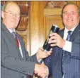  ??  ?? Clive Emson, right, receives his award from KCC chairman Tom Gates