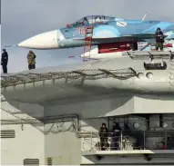  ??  ?? Heavily armed: Guards on the aircraft carrier