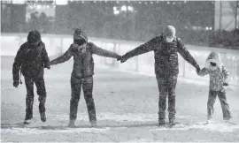  ?? SPENCER PLATT Getty Images ?? People ice-skate in Bryant Park in the snow on Wednesday in New York City.