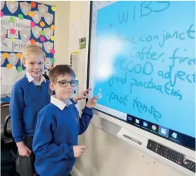  ?? Picture: Sue Corcoran ?? Lara Gregory, 8, and Tyler Henry inspect the new smart boards at St Nicholas Primary School in Hurst