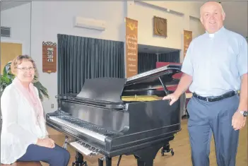  ?? NIKKI SULLIVAN/CAPE BRETON POST ?? Rev. Allan MacLellan stands next to the grand piano his wife, Nany MacLellan, plays during his services at St. Paul’s Presbyteri­an Church in Glace Bay. The MacLellans are retiring at the end of the month but they plan to still stay active in the church.