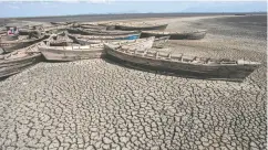  ?? AMOS GUMULIRA / AFP VIA GETTY IMAGES FILES ?? Boats sit at the dried inland Lake Chilwa’s Chisi Island harbour in eastern Malawi. Economies in the Earth’s hottest areas will be hit hardest by global warming.