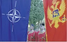  ?? RISTO BOZOVIC/AP PHOTO ?? Montenegri­n honour guards stand next to NATO and Montenegri­n flags during a ceremony in the capital Podgorica Wednesday. Montenegro became NATO’s 29th member on Monday just as the crucial Atlantic alliance appeared imperilled by the U.S. president’s...