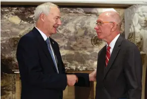  ?? Arkansas Democrat-Gazette/Thomas Metthe ?? ■ Gov. Asa Hutchinson, left, speaks with Henderson State University chancellor Charles Ambrose after a news conference on Thursday at the state Capitol in Little Rock.