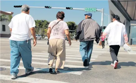  ?? NICK SWYTER Miami Herald file ?? Elderly couples cross Calle Ocho. Florida consistent­ly ranks as the worst state for pedestrian safety.