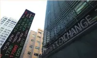  ?? (Reuters) ?? AN ELECTRONIC BOARD displays market data at the entrance of the Tel Aviv Stock Exchange.