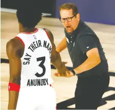  ??  ?? Coach Nick Nurse celebrates with forward OG Anunoby during the Raptors’ 104-99 win over the Nets on Wednesday. KEVIN C. COX/GETTY IMAGES