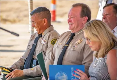  ?? Cory Rubin/The Signal (See additional photos at signalscv.com) ?? Los Angeles County Sheriff Jim McDonnell and Captain Robert Lewis share a laugh at the groundbrea­king ceremony for the new Santa Clarita Valley Sheriff’s Station on Golden Valley Road in Canyon Country on Wednesday.