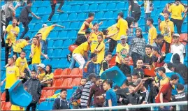  ?? AFP ?? ■ Angry spectators throw chairs ripped from the stands during a football match between Sriwijaya FC and Arema FC at the Gelora Sriwijaya Stadium, a venue for the upcoming Asian Games, in Palembang.