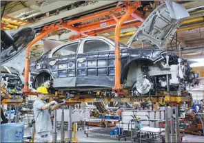  ?? ZHU WANCHANG / FOR CHINA DAILY ?? An employee works on a Volkswagen assembly line in Changchun, capital of Jilin province.