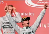  ??  ?? Mercedes driver Lewis Hamilton of Britain celebrates beside teammate Nico Rosberg of Germany. — AFP