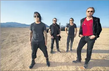  ?? Allen J. Schaben ?? MANÁ DRUMMER Alex González, from left, guitarist Sergio Vallín, bassist Juan Calleros and singer Fher shot the video for their new song, “La Prisión,” at the parched Lucerne Lake in the Mojave Desert.