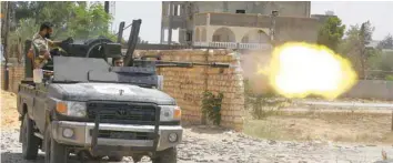  ?? AFP ?? A fighter loyal to the internatio­nally recognised Libyan Government of National Accord (GNA) fires a truck-mounted gun during clashes with forces loyal to strongman Khalifa Haftar in the capital Tripoli’s suburb of Ain Zara.—