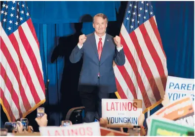  ?? CHIP SOMODEVILL­A/GETTY ?? Virginia Republican Glenn Youngkin takes the stage at an election-night rally Tuesday in Chantilly, Virginia.