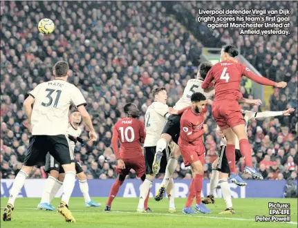  ?? Picture: EPA-EFE Peter Powell ?? Liverpool defender Virgil van Dijk (right) scores his team’s first goal against Manchester United at
Anfield yesterday.