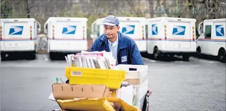  ?? DAVID GOLDMAN/AP 2013 ?? The Postal Service already delivers packages on Sundays for Amazon. Expanding the service to other e-retailers will boost its parcel business.