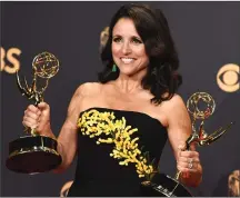  ?? Associated Press file photo by Jordan Strauss/Invision ?? In this Sept. 17, 2017 file photo, Julia Louis-Dreyfus poses in the press room with her awards for outstandin­g lead actress in a comedy series and outstandin­g comedy series for “Veep” at the 69th Primetime Emmy Awards in Los Angeles.