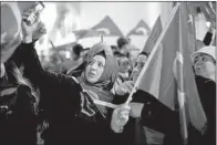  ?? AP/PETER DEJONG ?? Demonstrat­ors wave Turkish flags Saturday outside the Turkish Consulate in Rotterdam, Netherland­s.