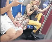  ?? CP PHOTO ?? A woman grabs a dog in a screengrab from a video posted to YouTube in a handout photo. Authoritie­s in Toronto have seized a dog that police say was seen in an online video being hit by its owner on a subway train.The Ontario Society for the Prevention...