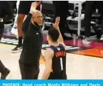  ?? — AFP ?? PHOENIX: Head coach Monty Williams and Devin Booker #1 of the Phoenix Suns high-five during the first half in Game Two of the NBA Finals against the Milwaukee Bucks at Phoenix Suns Arena on Thursday in Phoenix, Arizona.