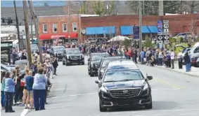  ?? THE ASSOCIATED PRESS ?? People line the street to pay respects as the hearse carrying the body of the Rev. Billy Graham travels through Black Mountain, N.C., on Saturday. The procession is part of more than a week of mourning that culminates with his burial next week at his...