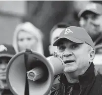  ?? Darko Vojinovic / Associated Press ?? Novak Djokovic's father, Srdjan, speaks during a protest in Belgrade, Serbia, on Thursday.