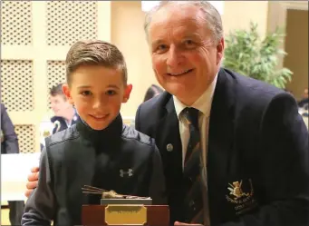  ??  ?? Jack McKenna, winner of the Shot of the Year Award, is presented with his trophy by Club Captain Bryan Collins at the Junior Captains Dinner and Awards Night at Laytown &amp; Bettystown Golf Club.