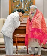  ??  ?? Chief Minister K. Chandrashe­kar Rao greets Prime Minister Narendra Modi in New Delhi on Friday.