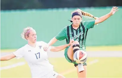  ?? JOSHUA MCKERROW/BALTIMORE SUN MEDIA GROUP ?? Severna Park's Emily Knight, left, and Arundel's Samantha Gotshall struggle for the ball in Wednesday’s game at Arundel. Knight helped the unbeaten Falcons win their fourth straight game. Severna Park needed double overtime to edge the Wildcats, 1-0.