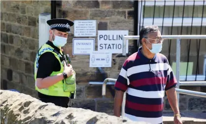  ??  ?? A police officer stands guard at a polling station as votes are cast in the Batley and Spen byelection. Photograph: Christophe­r Thomond/ The Guardian