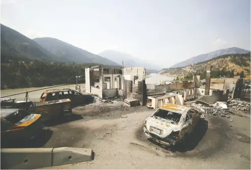  ?? DARRYL DYCK/THE CANADIAN PRESS ?? Destroyed and damaged structures and vehicles greeted returning residents of Lytton, B.C., on Friday after a wildfire destroyed most of the village on June 30, the day after the village set a heat record for Canada.