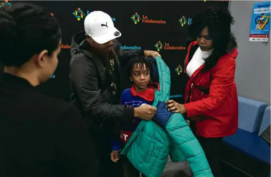  ?? STEVEN SENNE/ASSOCIATED PRESS ?? A family originally from Haiti that had been living in Chile for 11 years sought shelter this week in Chelsea.